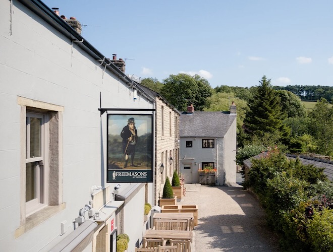 The exterior of the Freemasons at Wiswell on a sunny day.