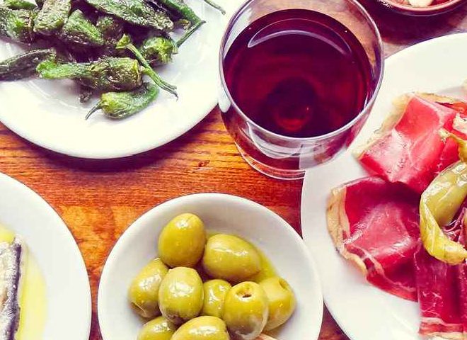 A table laded with tapas dishes at Porta Altrincham - a Spanish restaurant recommended by Confidential Guides