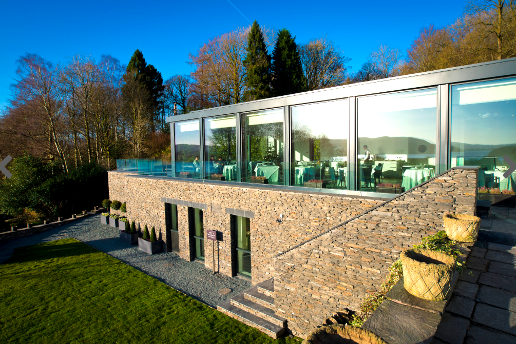 The glass-fronted dining room at The Samling has views of Lake Windermere
