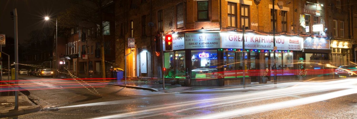 The exterior of The Great Kathmandu restaurant in West Didsbury, lit up at night