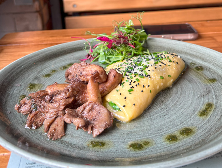 Rolled omelette garnished with chives and black sesame seeds, and mushrooms at The Pen & Pencil