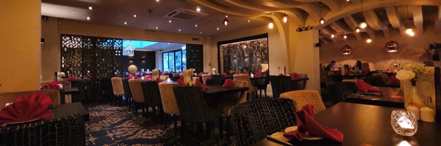 The softly lit interior of Holdi Woolton - an award-winning Indian restaurant in Merseyside.