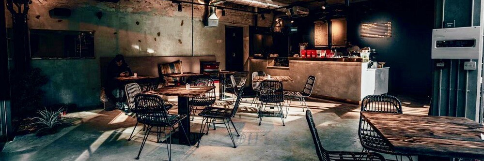 The cool, industrial interior of Gladstone Barber & Bistro - a recommended place to eat in Stalybridge, Greater Manchester.