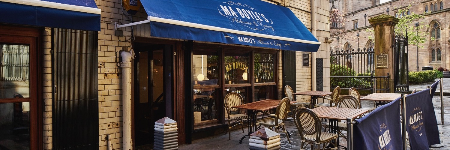 Tables set out for outdoor eating at Ma Boyles - a restaurant and pub near Albert Dock in Liverpool