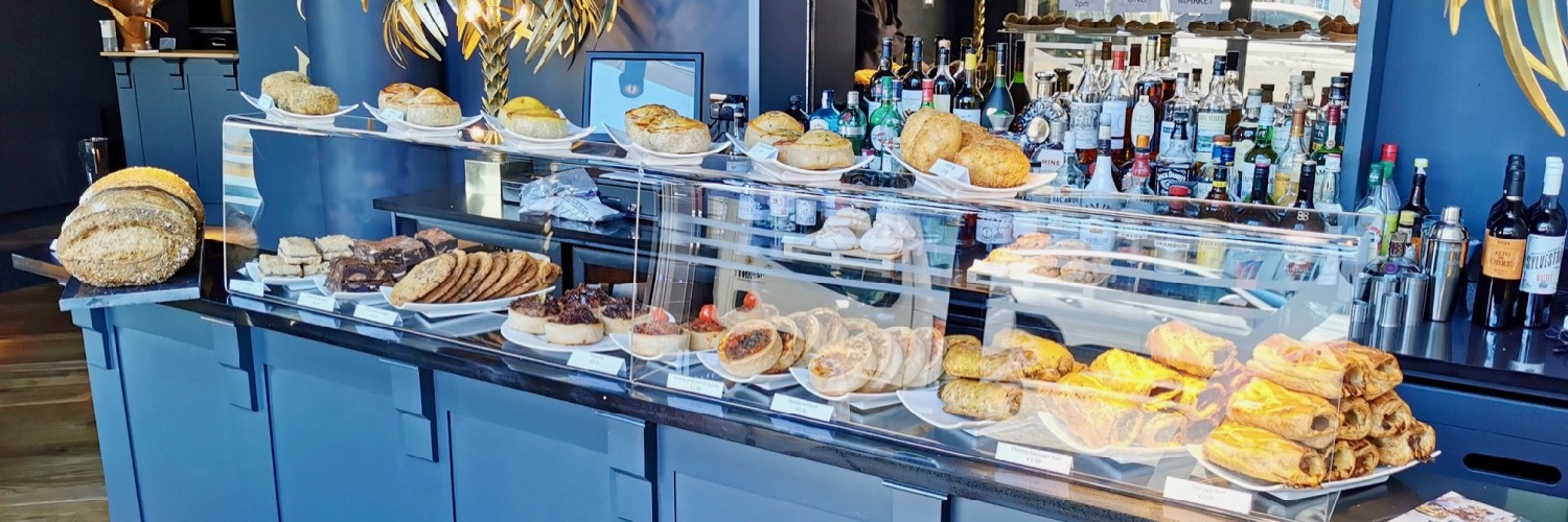 A counter displaying cakes, bread and pastries at Nova, a Modern British restaurant in Heswall, Wirral.