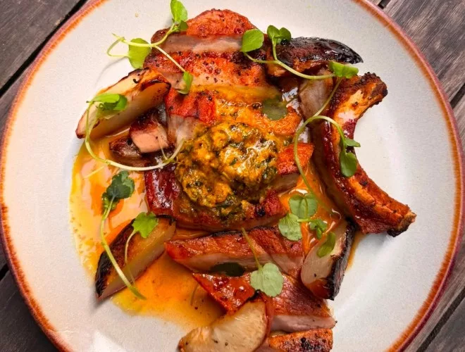 Pork chop, caramelised peaches, café de Paris butter and cider reduction at Queens
