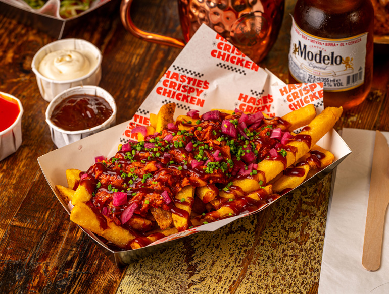 Thick-cut fries topped with pulled chicken, BBQ sauce, red pickled onions, and chopped chives at Pattersons, Liverpool