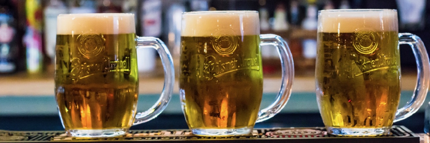 A line of tankers of Pilsner Urquell lined up on the bar at Cooper Hall, a beer hall in Manchester, NQ.