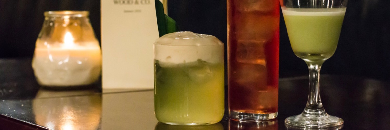 Cocktails lined up on the bar at Wood & Company - a secret subterranean bar in Manchester city centre.