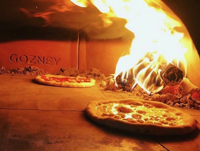 Stone-baked pizzas in the oven at Turncoat Bar at Albert Dock, Liverpool.