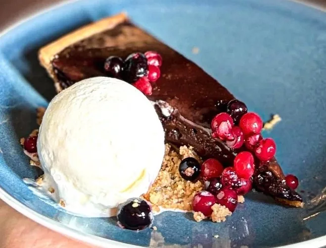 Dark chocolate tart with berries and double Jersey ice cream