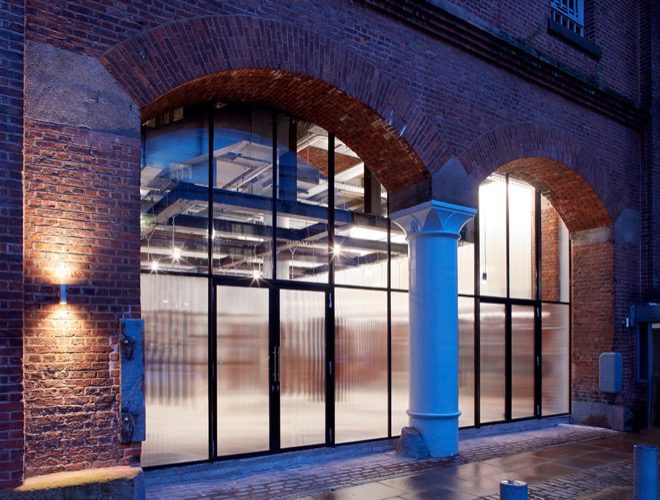 The exterior of BLOK Manchester at night - this class-based gym is based in Ducie Street Warehouse in Manchester city centre.