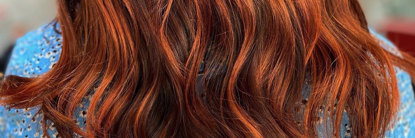 Close up of auburn coloured hair by Amy-sha Mother of Hairdressing - a top rated salon in Chorlton Manchester