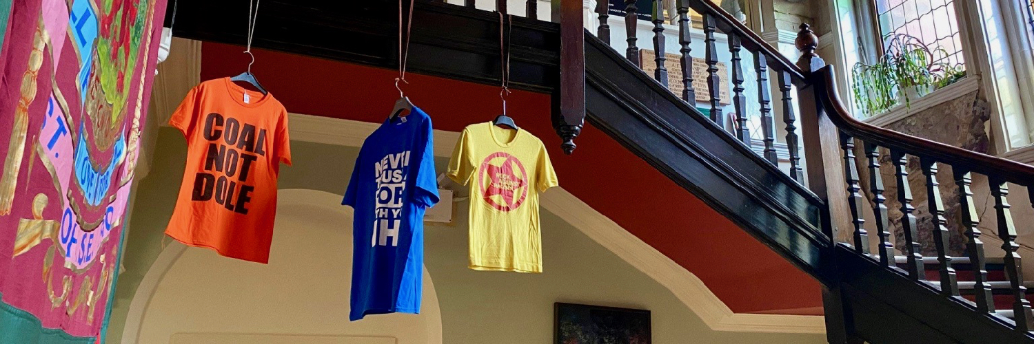 Protest T-shirts displayed at The Working Class Movement Library in Salford, Greater Manchester