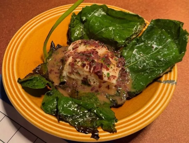 Cured cod grilled over coals in a fig leaf at Higher Ground