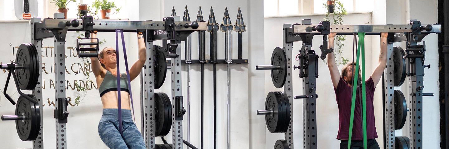 People doing pull-ups at The Olympus Projects, a gym in Manchester city centre.