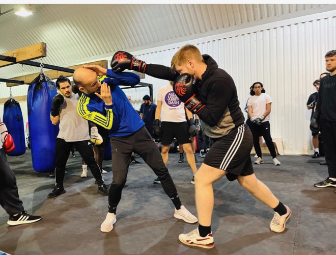 Coach Josh Cook teaching boxing at Fighting Fit gym in Manchester