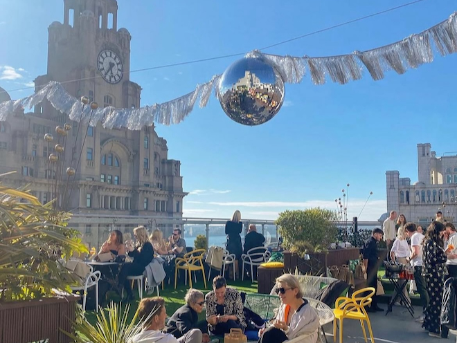 The rooftop terrace at Goodness Gracious Me / Oh Me Oh My with the Liver Building in the background.