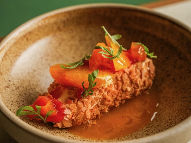 A frozen vanilla parfait coated in a passionfruit glaze and served with a poached clementine and fresh blood orange at Nord in Liverpool.