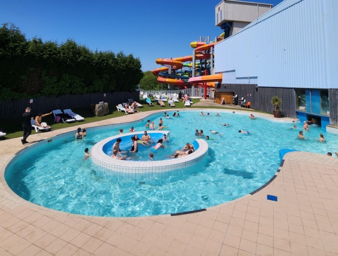 The outdoor pool at Waterworld in Stoke with tube slides in the background