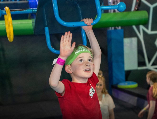 Child on the bars at Total Ninja