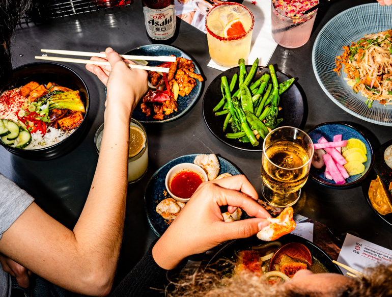 Communal eating, various dishes and drinks at Wagamama, Manchester