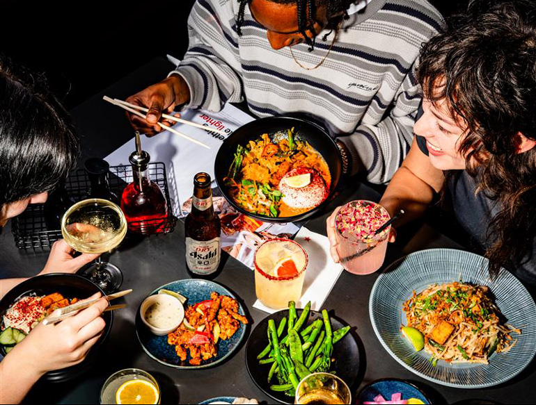 Communal eating, various dishes and drinks at Wagamama, Manchester