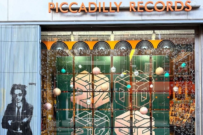 Piccadilly Records storefront with John Cooper Clarke graffiti on shutters