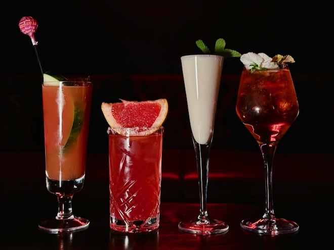 Four cocktails served at Behind Closed Doors in Manchester lined up on the bar.