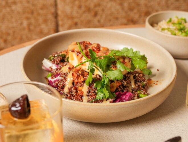 Halloumi and quinoa topped with coriander in a bowl, served at Caravan in Manchester.