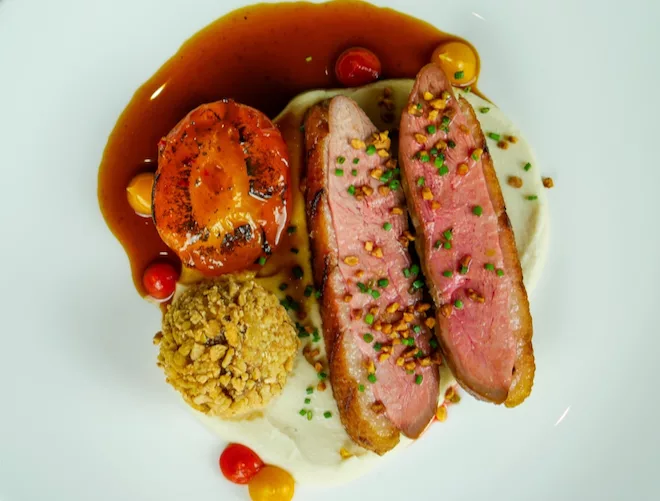 Cape-Malay Duck Breast with duck croquette, almond cream, roasted apricot, apricot and sambal gel and a curried burnt orange jus at Barnacle in Liverpool.
