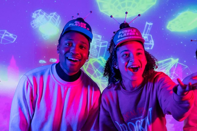 A couple at Immersive Gamebox wearing hats with sensors