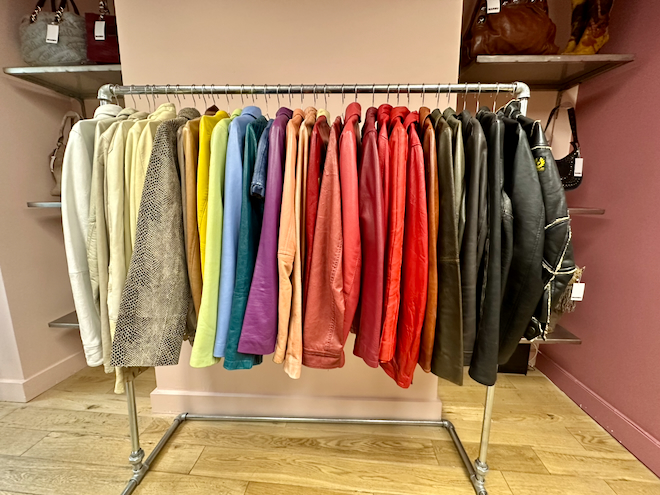 A rack of jackets arranged in rainbow colours at Marbu in Manchester.