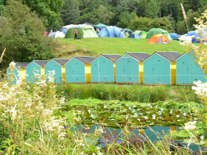 Brightly coloured huts and tents at Buckle and Boots Festival in Etherow Park.