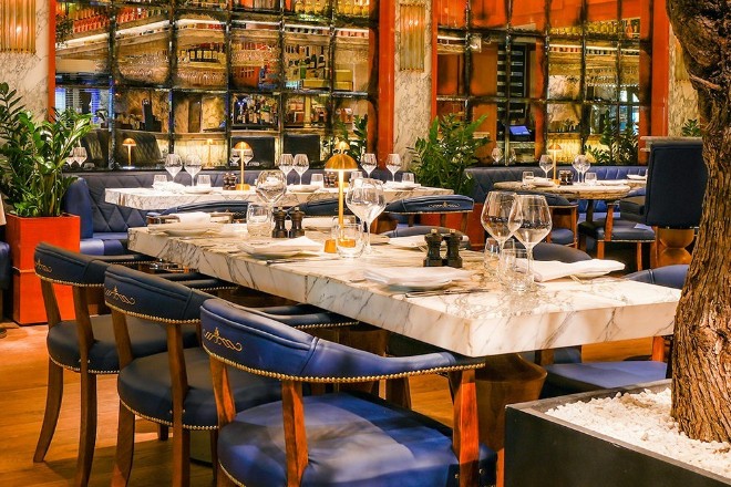 Interior of Cibo Gran Cafe in Wilmslow with blue velvet high stools and marble high tables