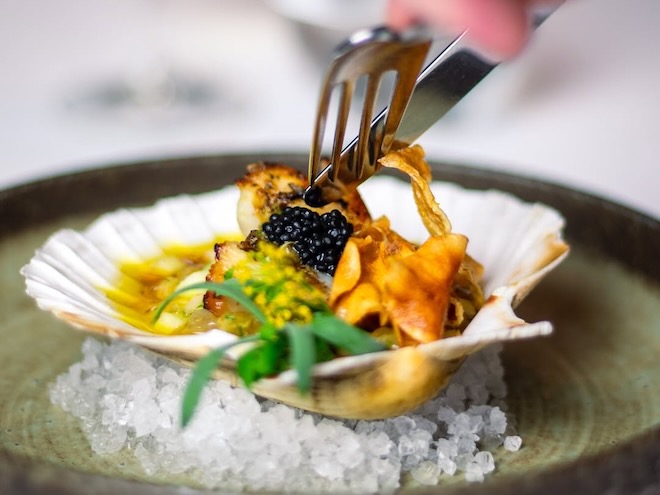 Loch Fyne King scallop served in the half shell at The Art School Cellars in Liverpool.