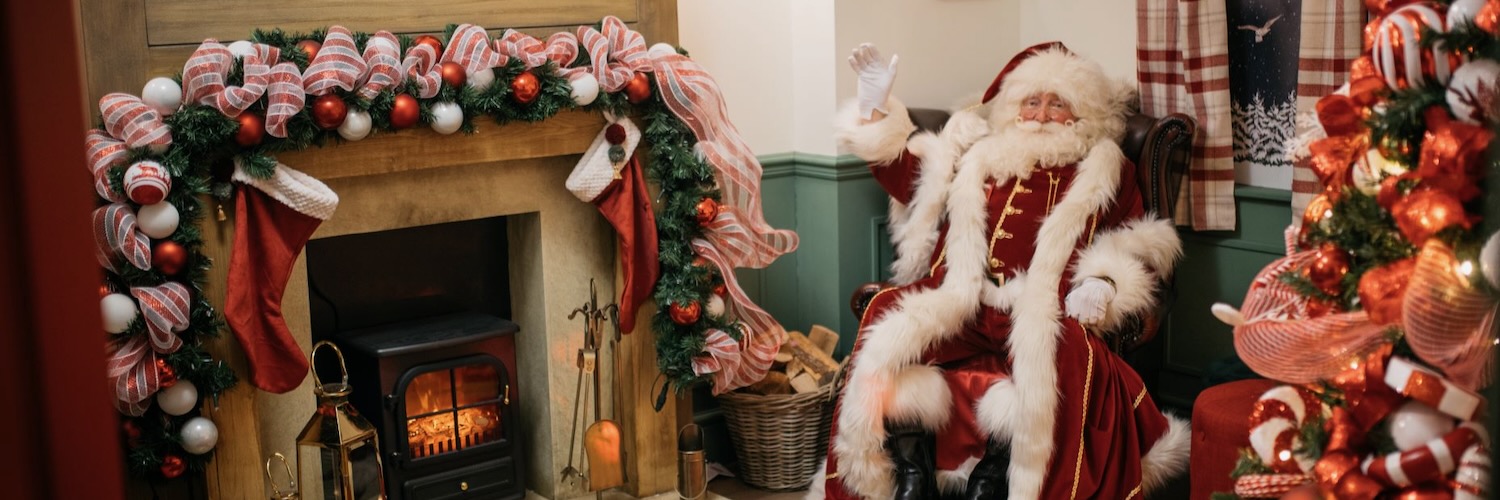 Santa Claus waving from inside his grotto at The Trafford Centre.