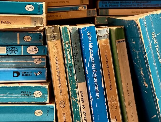 A shelf of blue, secondhand, vintage Penguin books at George Street Bookshop, Glossop.