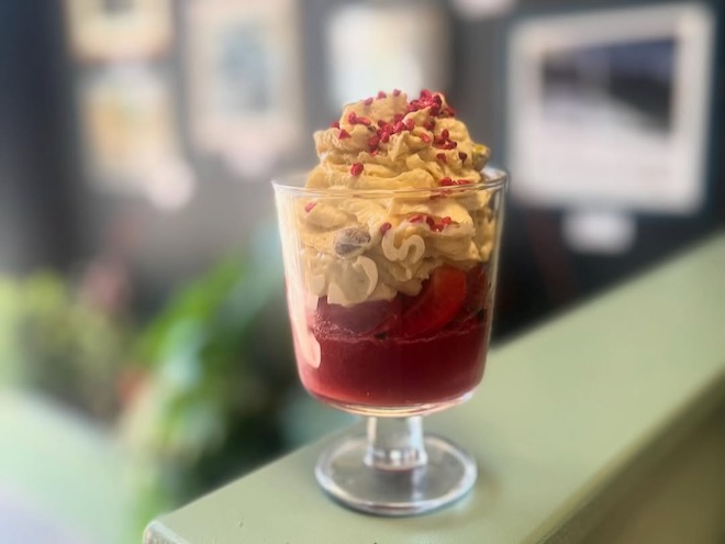 Trifle with fresh strawberry jelly, pistachio sponge and Woodruff cream served at The Two Hares in Glossop.