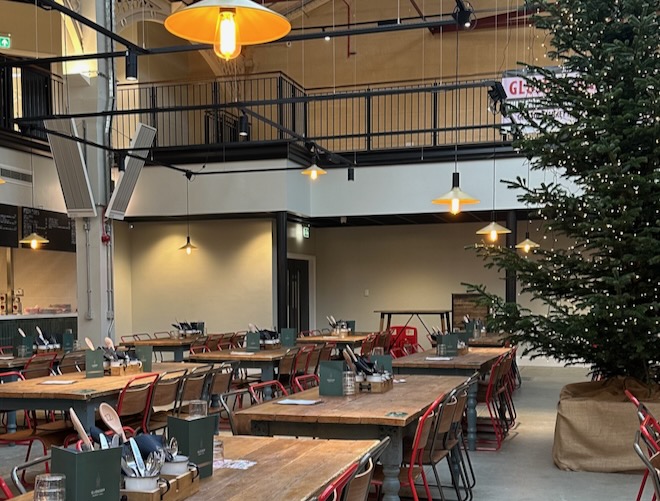 Communal tables and a Christmas tree at Glossop Market Hall.
