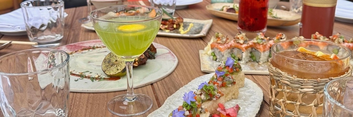 A table of cocktails and small plates at Chotto Matte