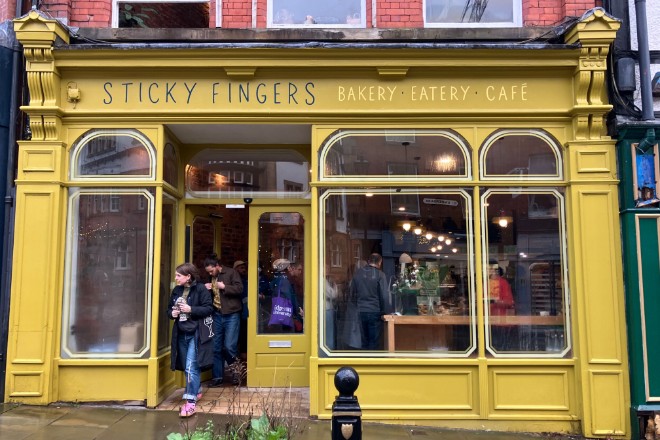 The bright yellow exterior of Sticky Fingers in Stockport