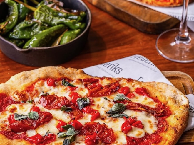 Homemade pizza margherita and a bowl of padron peppers at Frederiks in Liverpool.