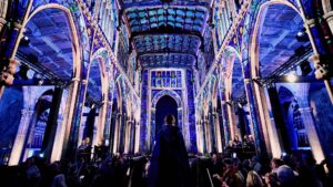 Cathedral interior lit up with purple lights from the Luminescence show.