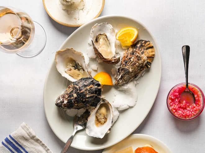 An oval dish of oysters with lemon quarters served at Winsome in Manchester.