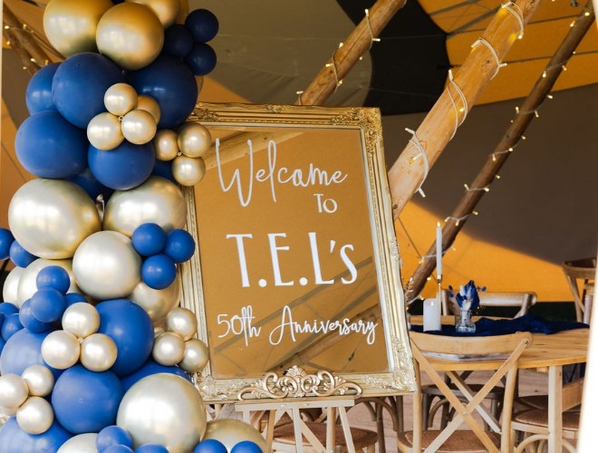 A balloon arch and welcome board for a corporate event at Swanley Meadows