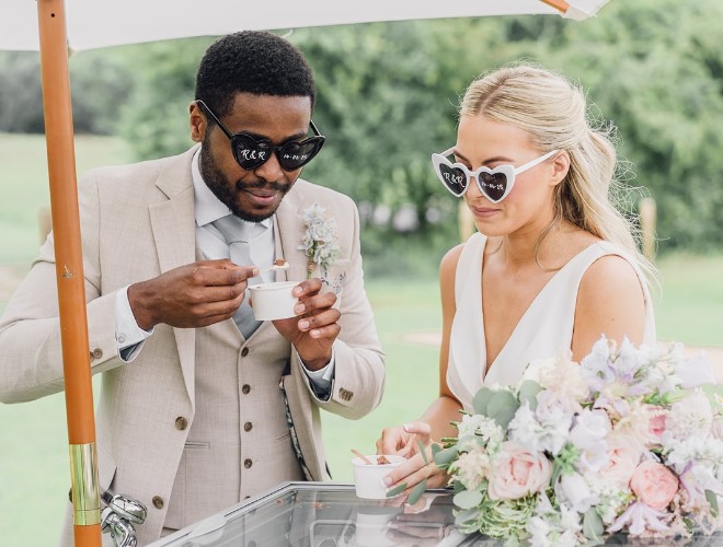 Bride and groom enjoying ice cream from a traditional cart
