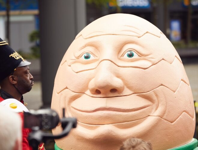 A model of Humpty Dumpty with a man dressed as a soldier looking on.