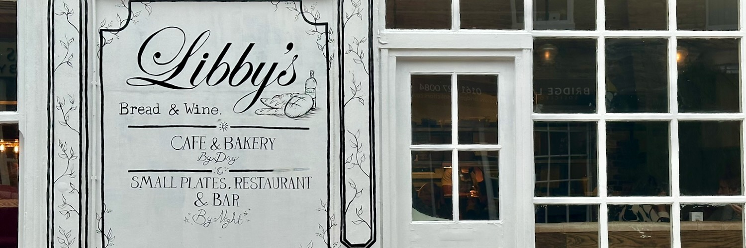The windows, door and sign at the front of Libby's Bread & Wine.