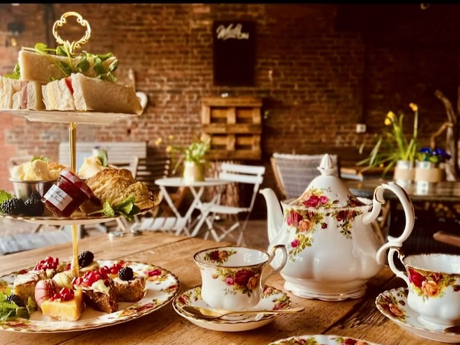 Afternoon tea in Royal Albert china in a rustic setting at Dunham Barn